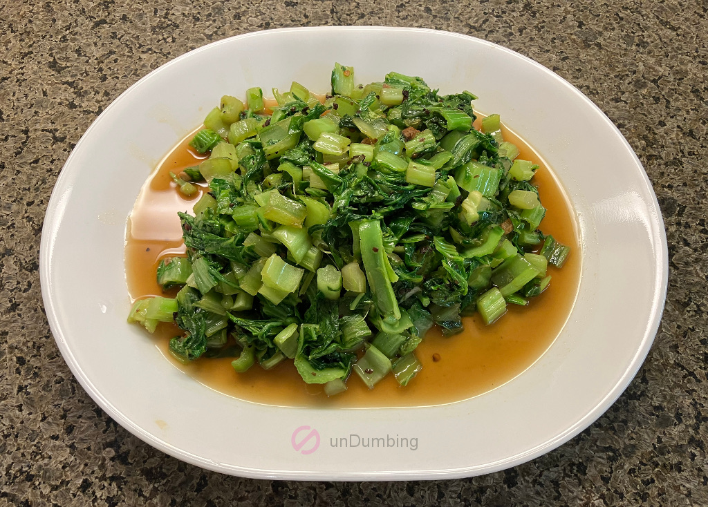 Stir-fried Mustard Greens (Sher Li Hon) on a white plate