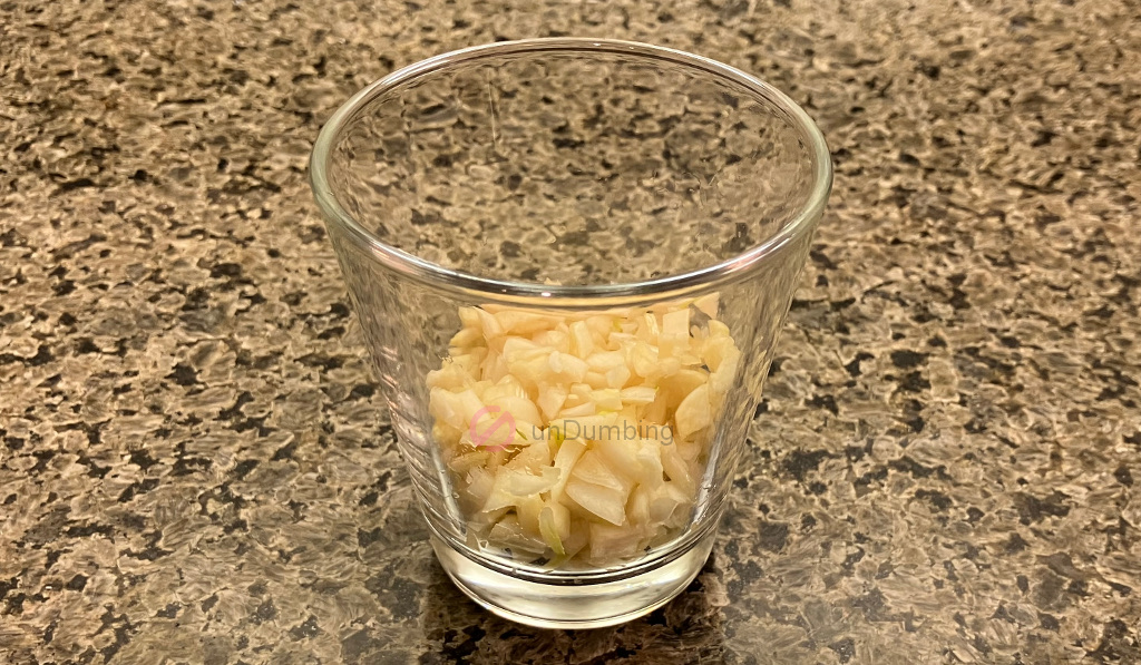 Minced garlic in a shot glass
