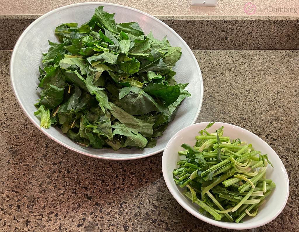 Taiwan spinach leaves in a wok cover and stems in a white bowl