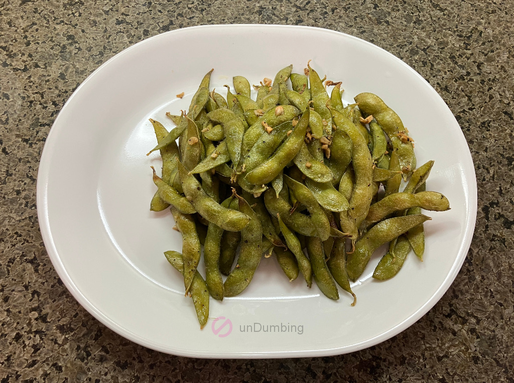Simple roasted edamame on a white plate