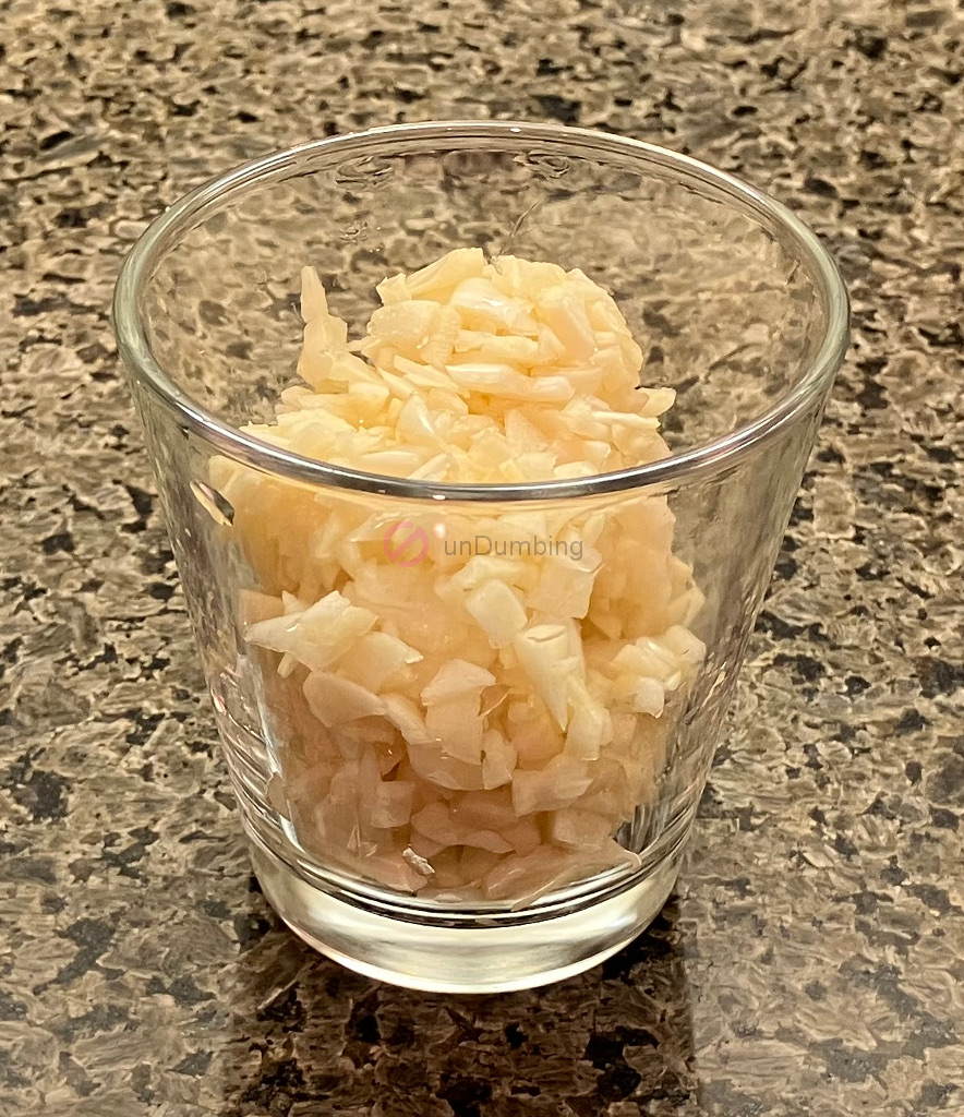 Chopped garlic in a shot glass