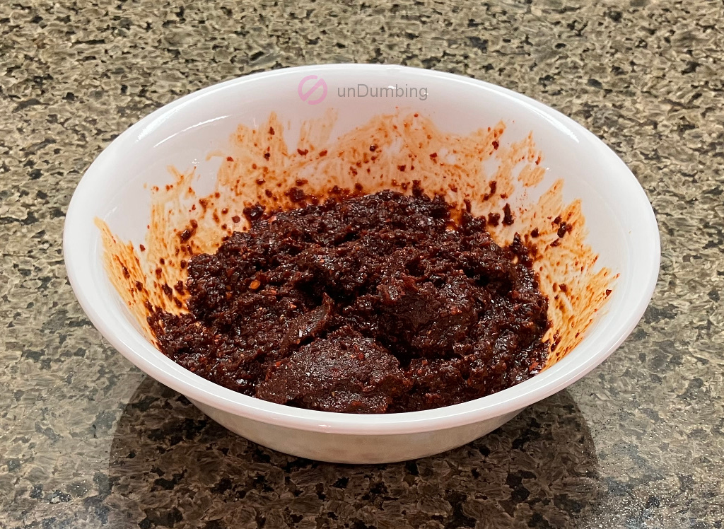 Soy sauce and pepper powder mixture in a white bowl